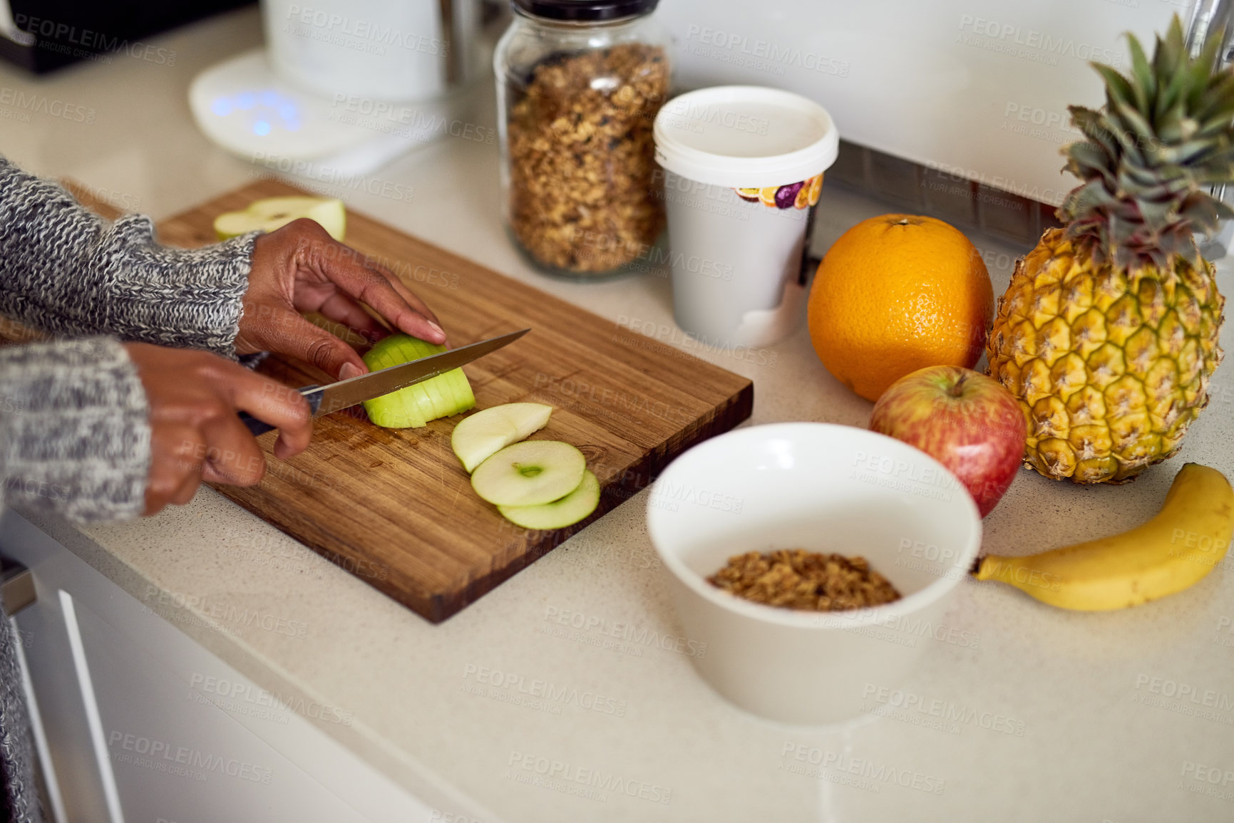 Buy stock photo Home, apple and hands with breakfast on board for eating, healthy and diet nutrition in morning. House, counter or person with knife in kitchen for cutting, organic fruit or vegan recipe for snack