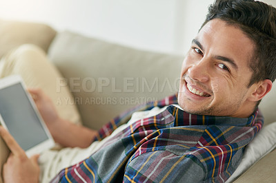 Buy stock photo Portrait, smile and tablet with man on sofa in living room of home to relax for entertainment streaming. Internet, social media and technology with happy person in apartment for weekend time off