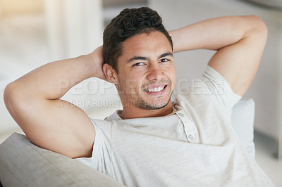 Buy stock photo Portrait of a happy young man relaxing on the sofa at home
