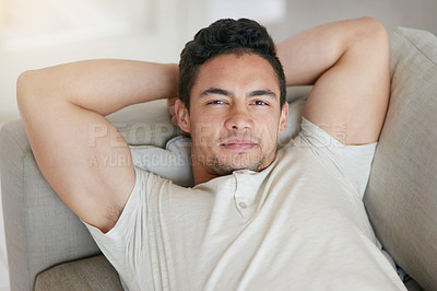 Buy stock photo Portrait of a young man relaxing on the sofa at home