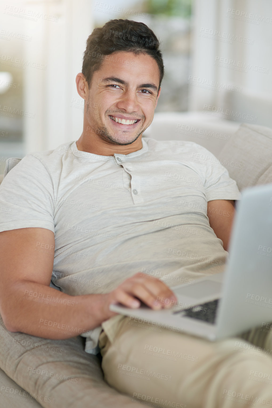 Buy stock photo Portrait, smile and laptop with man on sofa in living room of home to relax for entertainment streaming. App, internet or technology and happy person in apartment with computer for weekend time off