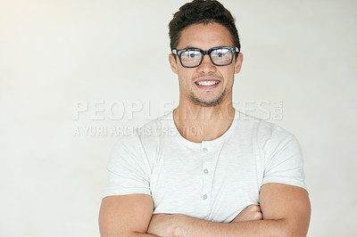 Buy stock photo Studio portrait of a confident young man posing against a light background