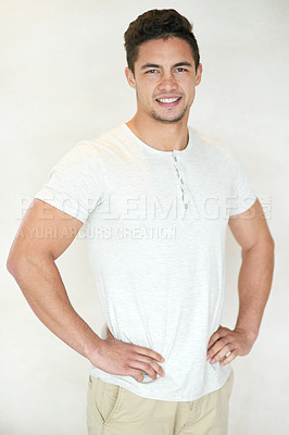Buy stock photo Studio portrait of a confident young man posing against a light background