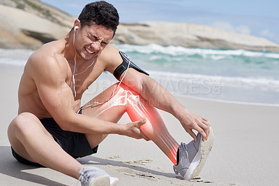 Buy stock photo Shot of a handsome young man holding his calf in pain during a workout