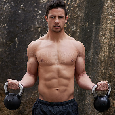 Buy stock photo Portrait of a handsome young man working out with kettle bells outside