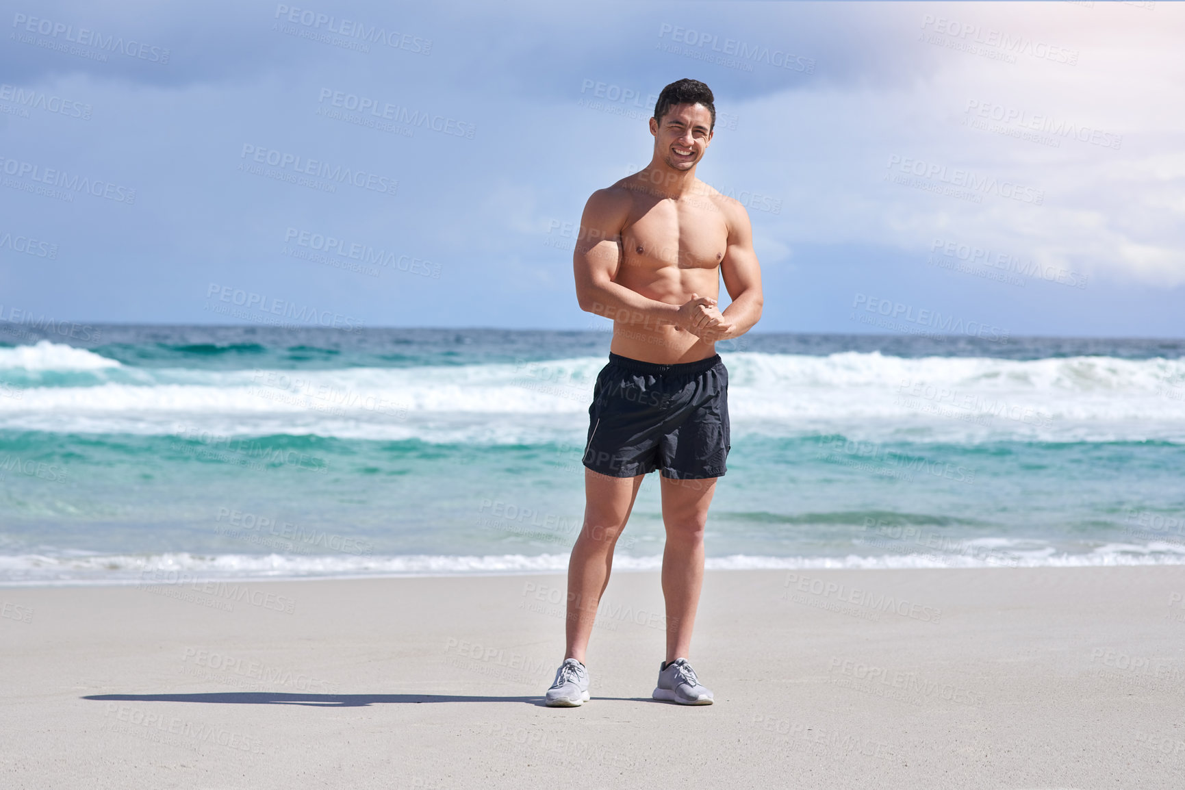 Buy stock photo Body, portrait and smile of man on beach in summer for holiday, travel or vacation. Sand, sea and sky with happy, muscular or shirtless person on coast by ocean for exercise, fitness and workout