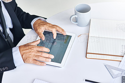 Buy stock photo Cropped shot of a corporate businessman working on a digital tablet in an office