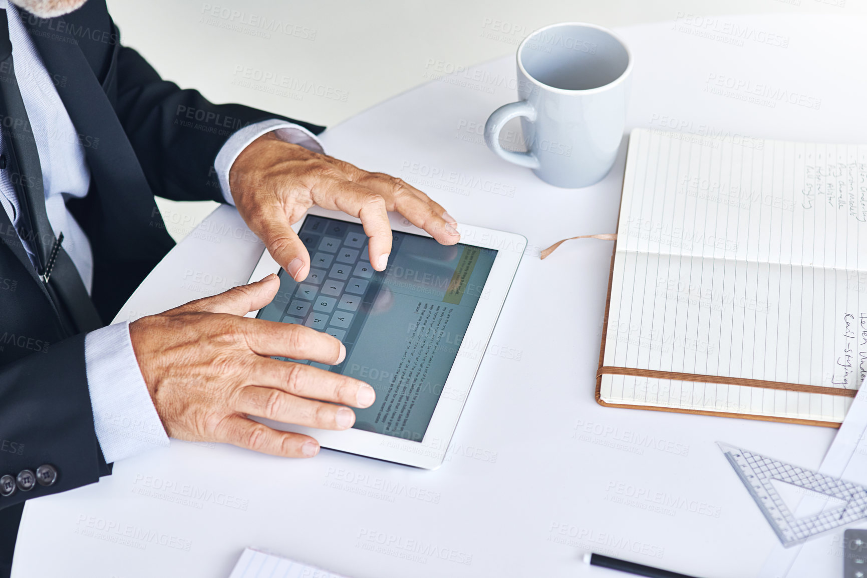 Buy stock photo Cropped shot of a corporate businessman working on a digital tablet in an office