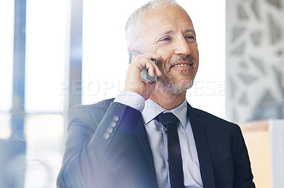 Buy stock photo Cropped shot of a mature businessman talking on a cellphone in an office