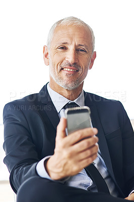 Buy stock photo Portrait of a mature businessman texting on a cellphone in an office