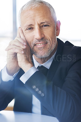 Buy stock photo Portrait of a mature businessman looking thoughtful while sitting in an office