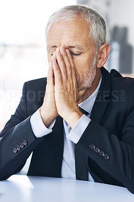 Buy stock photo Cropped shot of a mature businessman looking stressed out at work