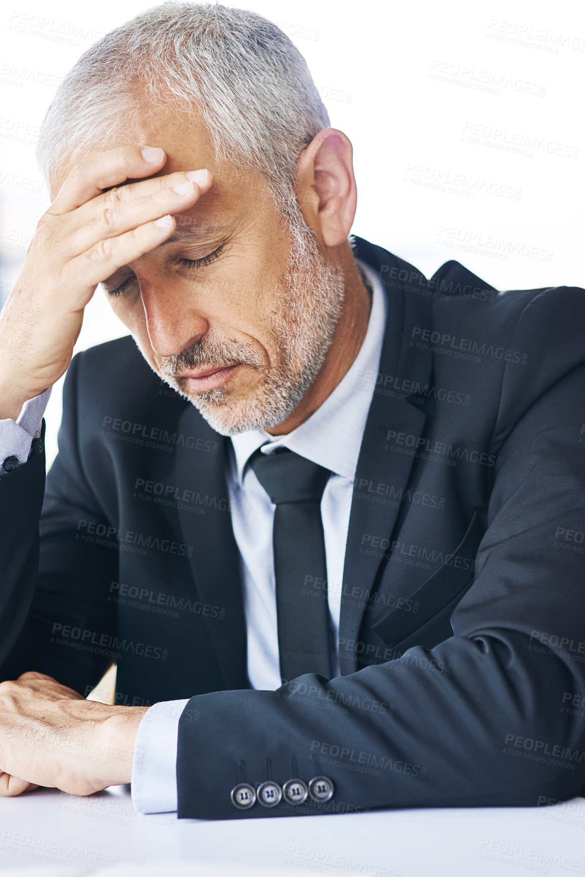 Buy stock photo Cropped shot of a mature businessman looking stressed out at work