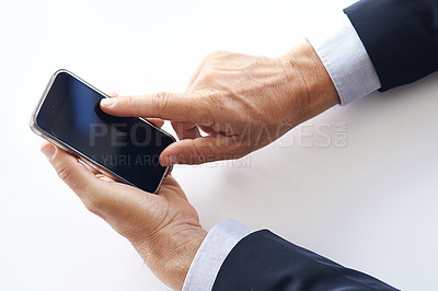 Buy stock photo Closeup shot of a businessman using a cellphone against a white background