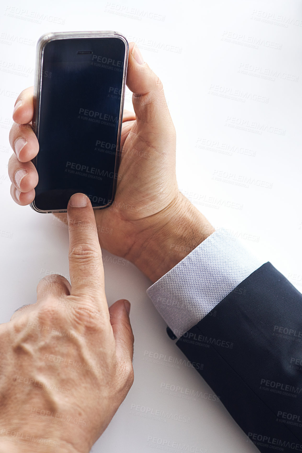 Buy stock photo Closeup shot of a businessman using a cellphone against a white background