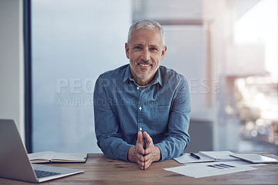 Buy stock photo Shot of a businessman in casual clothes working in his office