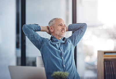 Buy stock photo Cropped shot of a mature businessman taking a break at his office desk