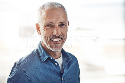 Buy stock photo Portrait of a confident mature businessman standing in an office