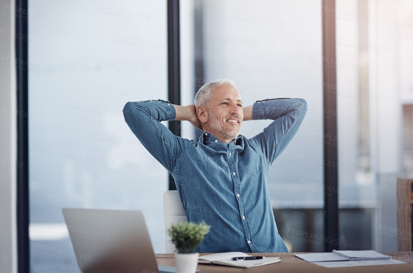 Buy stock photo Cropped shot of a mature businessman taking a break at his office desk