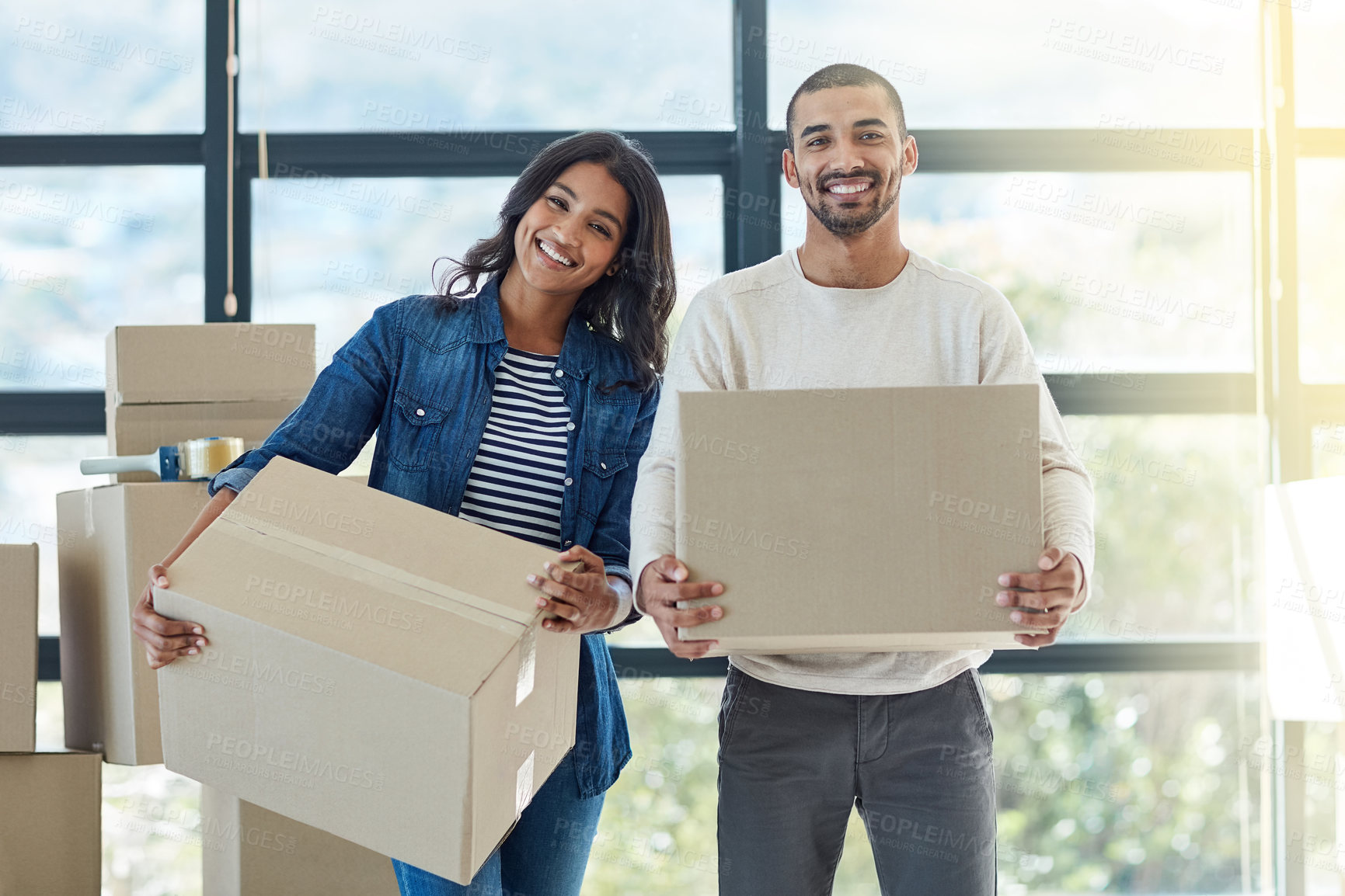 Buy stock photo Portrait of a happy young couple moving into their new home together