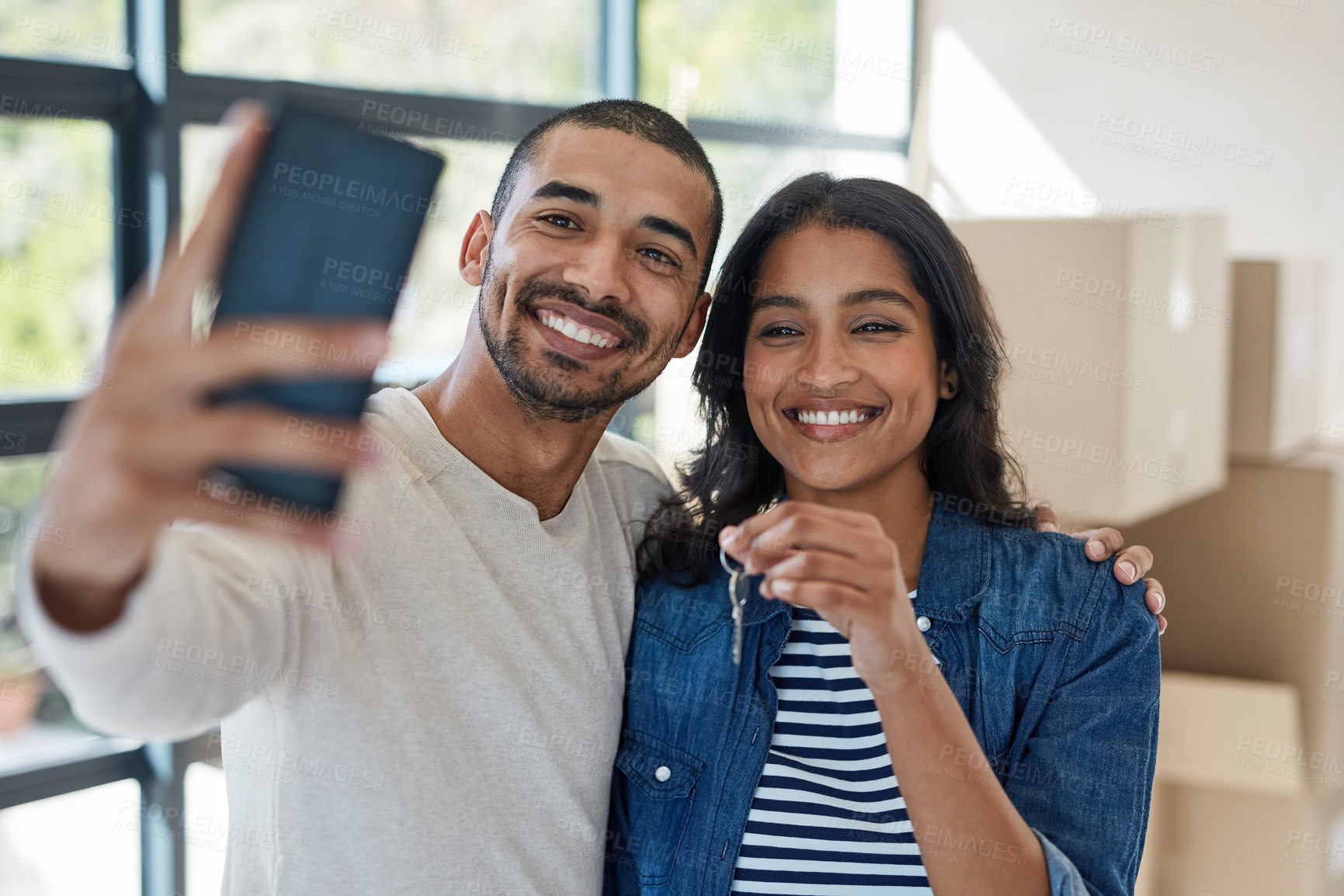 Buy stock photo Selfie, house key and couple moving to new home together with cardboard boxes for real estate. Happy, love and young man and woman with photography picture for apartment or property ownership.