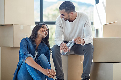 Buy stock photo Shot of a happy young couple moving into their new home together