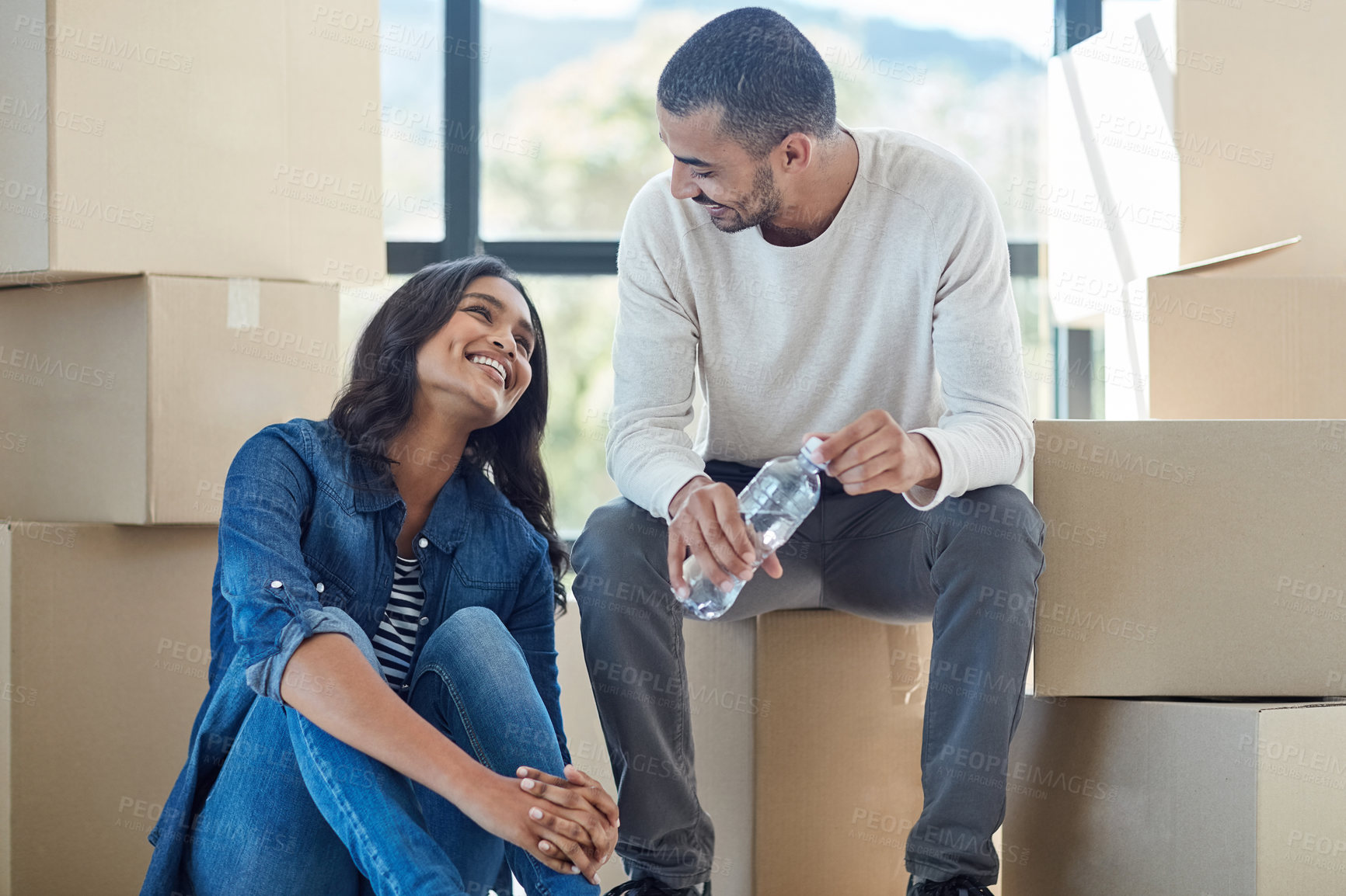 Buy stock photo Couple, relax and boxes for moving to new home with support, bonding and happiness for dream house. Homeowner, man and woman in relationship excited for relocation, property investment or purchase