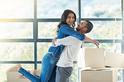 Buy stock photo Portrait of a happy young couple moving into their new home together
