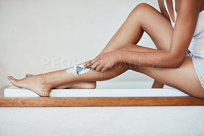 Buy stock photo Cropped shot of a woman shaving her legs with a razor and shaving cream