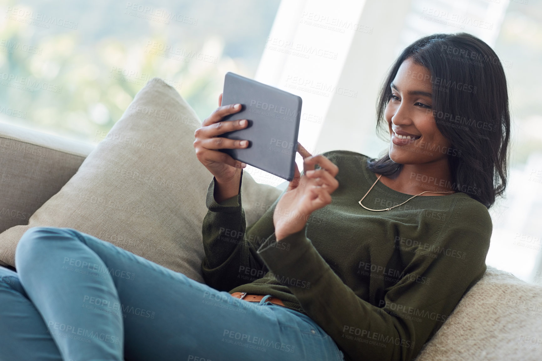 Buy stock photo Happy woman, relax and browsing with tablet on sofa for online entertainment, show or streaming service at home. Female person with smile on technology for scrolling, movie or subscription at house