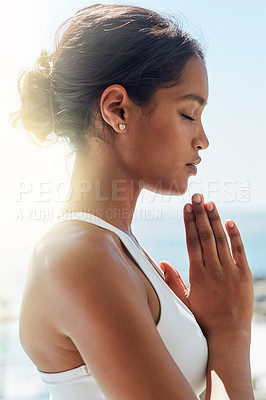 Buy stock photo Cropped shot of a young woman doing yoga exercises