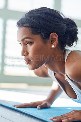 Buy stock photo Shot of a sporty young woman working out
