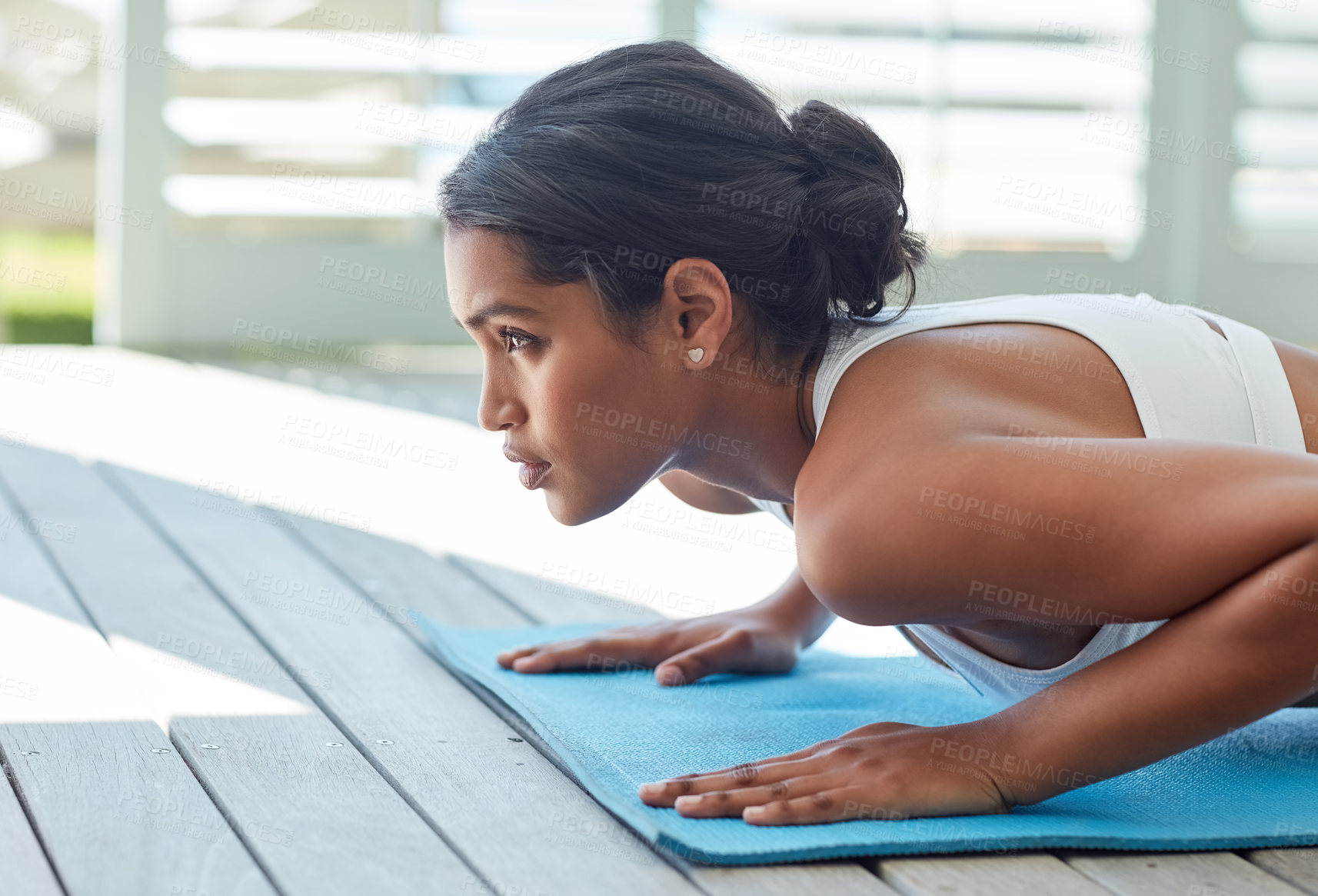 Buy stock photo Shot of a sporty young woman working out