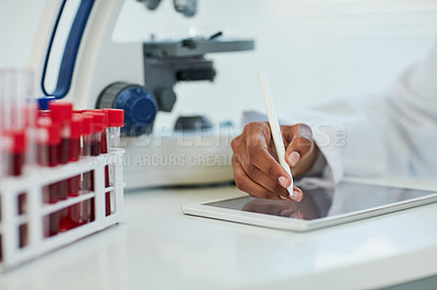 Buy stock photo Closeup shot of a female scientist recording her findings on a digital tablet