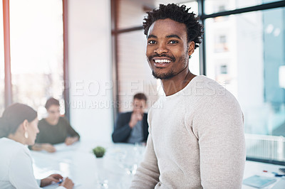 Buy stock photo Portrait of a businessman in an office with his colleagues in the background