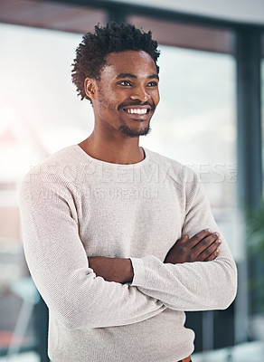Buy stock photo Shot of a successful businessman standing with his arms folded in the office