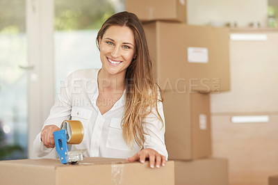 Buy stock photo Portrait of a smiling young woman packing boxes on moving day