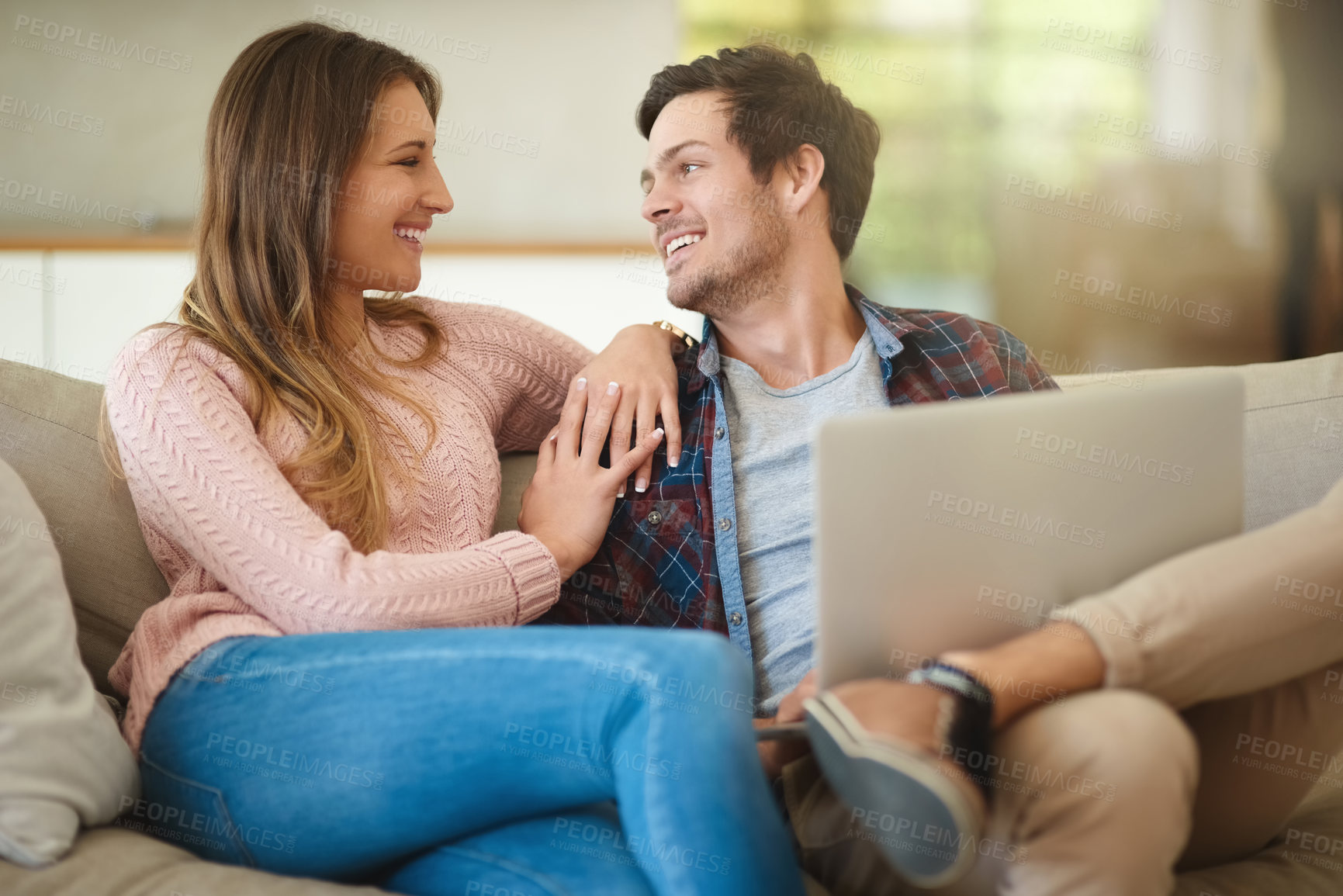 Buy stock photo Couple, laptop and sofa with love for relaxing on weekend with tech for online streaming in house. People, happy and relationship with movie in living room on couch for romance with subscription.