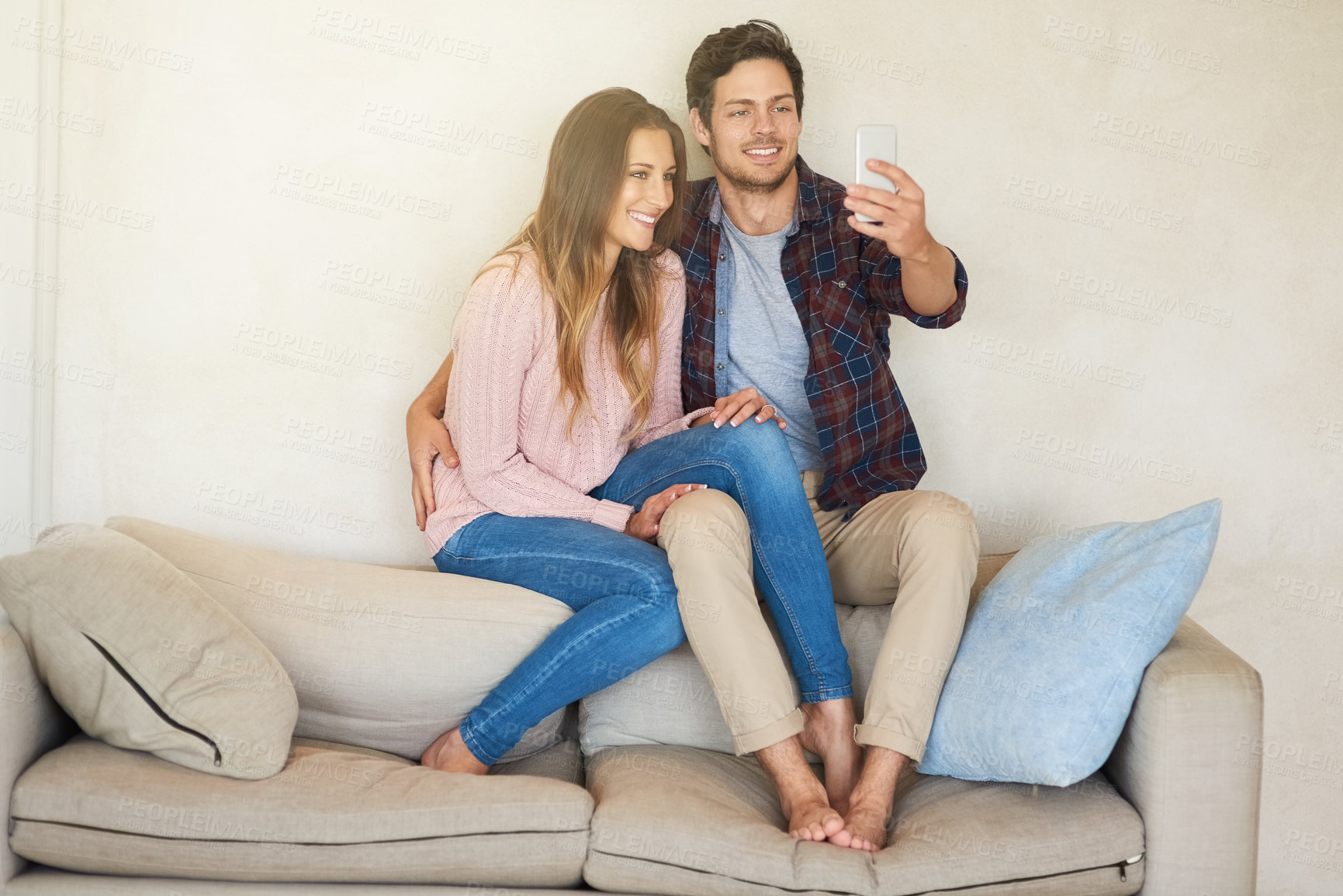 Buy stock photo Couple, smile and selfie in house on sofa for relax, social media and holiday together. Man, woman and happiness in home living room for online post, memory and vacation with love, peace and date