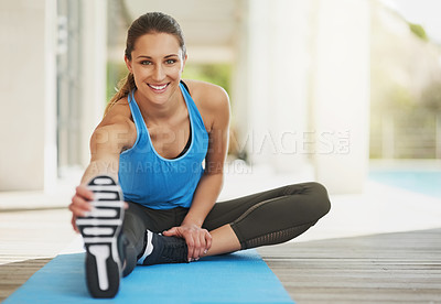 Buy stock photo Portrait of an attractive young woman stretching before her workout