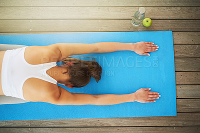 Buy stock photo High angle shot of a young woman working out at home