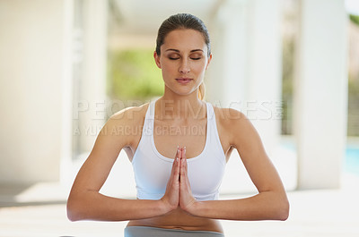 Buy stock photo Shot of an attractive young woman meditating on her patio