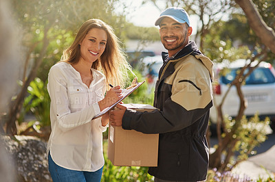 Buy stock photo Portrait of a courier delivering a package to a smiling young woman at home