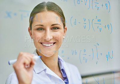 Buy stock photo Portrait of a young female scientist writing equations on a glass wall in a lab