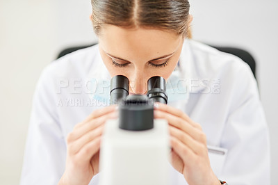 Buy stock photo Cropped shot of a young female scientist working in a lab