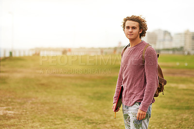 Buy stock photo Portrait of a young man standing outside in a field