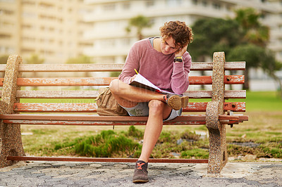 Buy stock photo Notebook, nature and man on bench writing for college test, research and assignment studying. Reading, information and male student preparing for university exam on wooden seat in outdoor park.