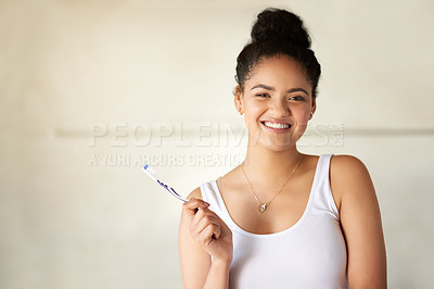 Buy stock photo Portrait of a happy and attractive young woman brushing her teeth