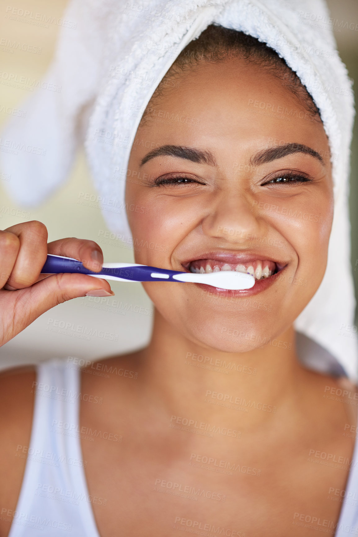 Buy stock photo Portrait of a happy and attractive young woman brushing her teeth