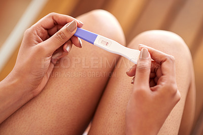 Buy stock photo Cropped shot of a woman taking a pregnancy test